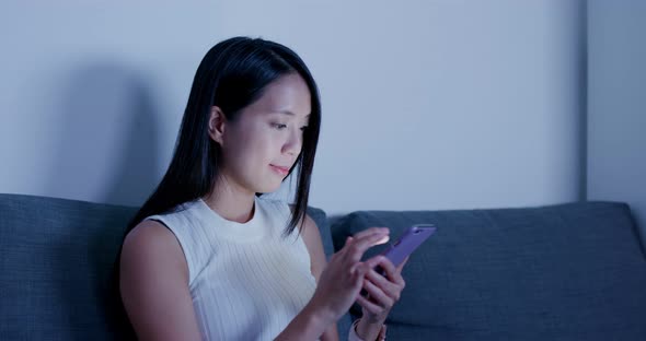 Woman Search on Smart Phone and Sit on Sofa at Home