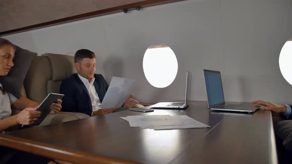Businesspeople Have Private Deal Discussion Inside of Business Jet