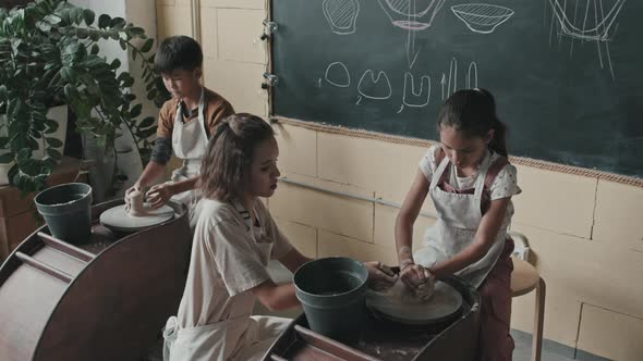 Ceramist Teaching Girl Use Pottery Wheel