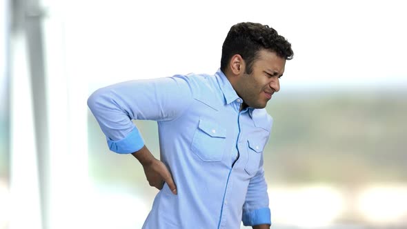 Young Indian Man Suffering From Back Ache.