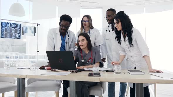 Five Young Doctors Using Laptop Together in the Hospital.