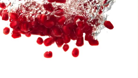 Super Slow Motion Pomegranate Grains Fall Under the Water with Air Bubbles