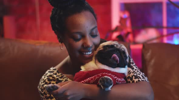 Portrait of African Woman with Cute Pug Dog Having Video Call Sitting at Home