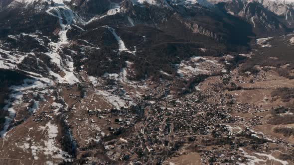 Pan up drone shot from Cortina d'Ampezzo to surrounding Mountains Dolomites Italy