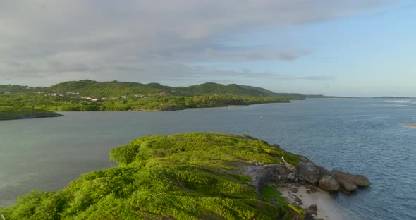 Aerial of green landscape along calm sea, Cap Chevalier, Sainte-Anne