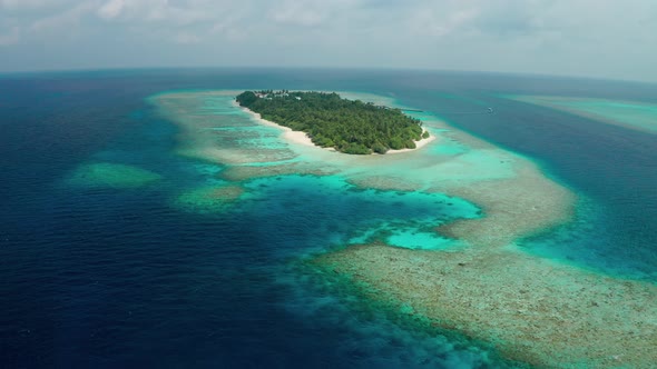 Flying a drone around a tropical island with coconut trees in the Maldives