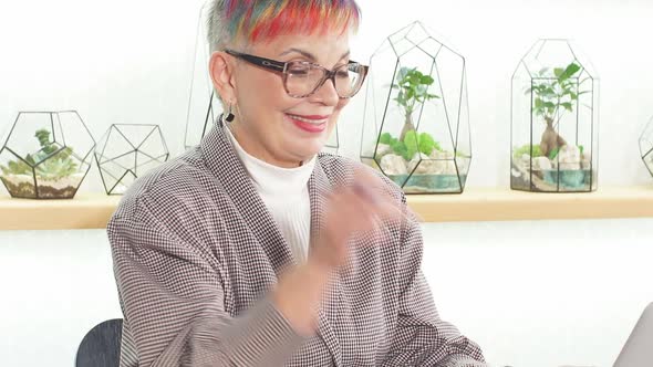 Close Up Confident Senior Woman Wearing Glasses Sit Working on Laptop in White Office Room