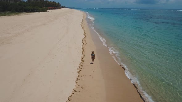 Girl Walking on the Beach