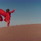 An Asian Woman in a Red Dress Dancing on Sand Dunes - VideoHive Item for Sale