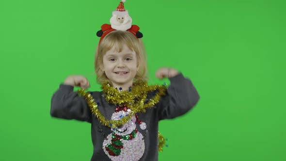 Happy Beautiful Little Girl in a Sweater with a Snowman. Christmas. Chroma Key