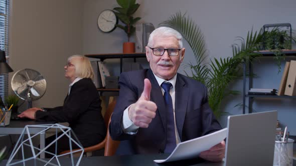 Cheerful Senior Manager Showing Thumbs Up Approval Gesture Satisfied with Good Results of Work