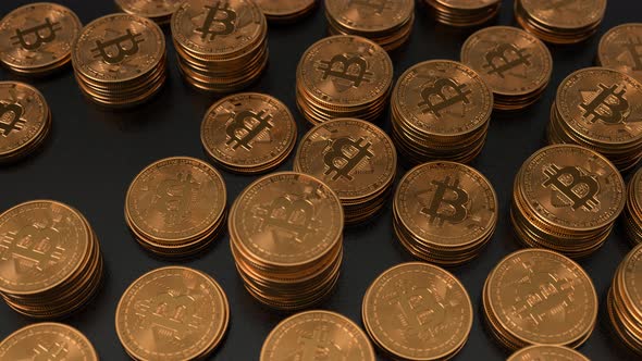 Bitcoins stacked on glossy black background