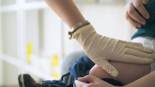 Professional Doctor Makes Vaccination Injection in Baby Leg