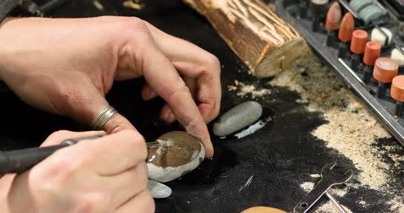 Close Up Male Hands Using Power Stone Working Tools Graver Carving While Crafting