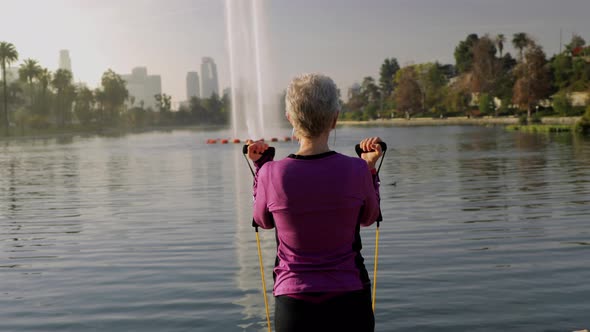 Senior Woman Working Out In The Park