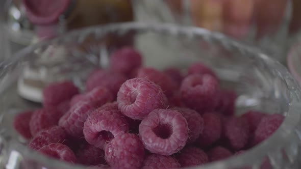 Closeup of fresh raspberries in a bowl in a kitchen with shallow depth of field