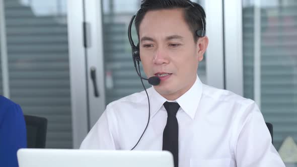 Businessman Wearing Headset Working Actively in Office