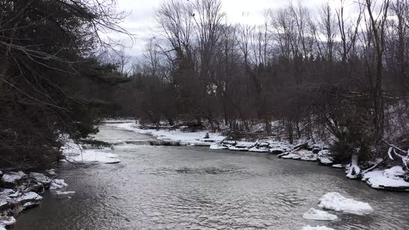 icy winter river with mini waterfall