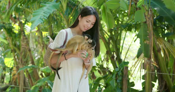 Woman tourist go to the park for visit  Squirrel Monkey