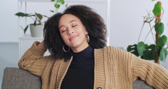 Portrait Mixed Race Afro American Girl Woman Relaxing at Home Living Room Sitting on Sofa with