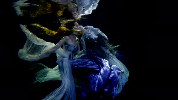 A Mysterious Mermaid Swims Underwater Like in a Fairy Tale with a Dragon