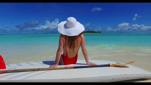 Man and woman tanning on tropical lagoon beach vacation by blue sea with white sand background of th