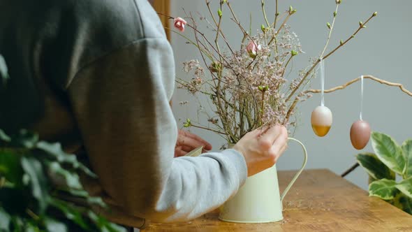 Woman Making DIY Easter Decoration for Home Interior