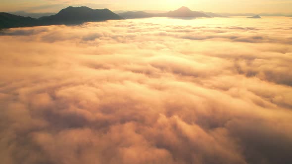 4K Drone Flying through the clouds at dusk or dawn. Aerial top cloudscape