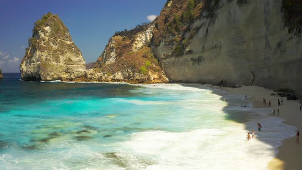 The Famous Beach and Tourist People Are Swimming on Diamond Beach in Nusa Penida Island, Bali