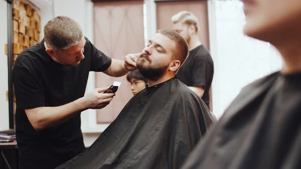 Barber Smoothes the Hair on the Man's Neck Beard Cutting