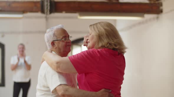 Medium Shot of Senior Couple Dancing Waltz in Ballroom