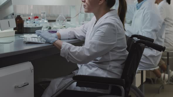 Disabled Female Scientist Working on Computer in Lab