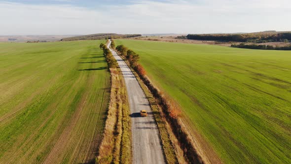 Zoom aerial view of autumn road car