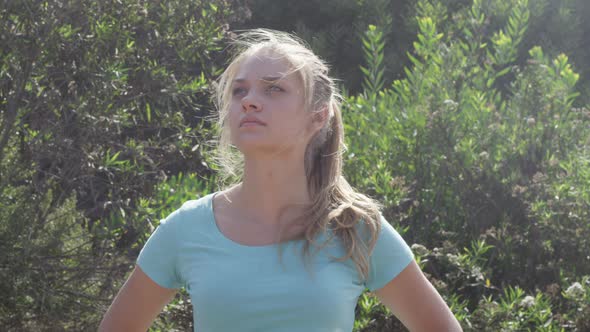 A young woman runner resting after jogging.