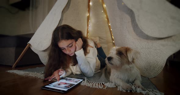 Woman Lying on the Floor with the Dog Jack Russell and Use Tablet