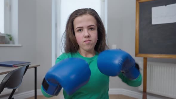 Front View Confident Female Boxer Fighting Shadow Looking at Camera