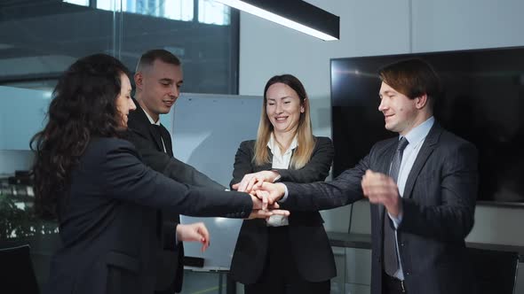 Motivated Business Team Putting Hands in Stack