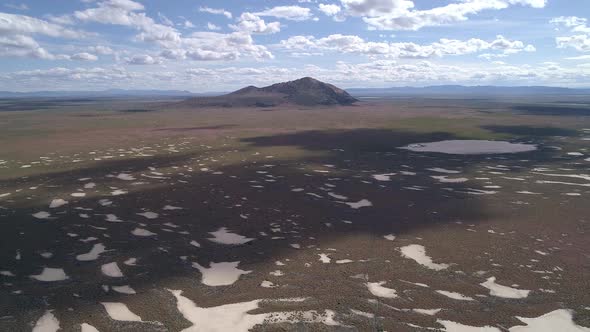 Flying over desert landscape in Utah viewing volcanic butte