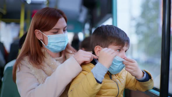 Female Passenger Together with His Son Take Precautions in Public Place and Wear Medical Mask To