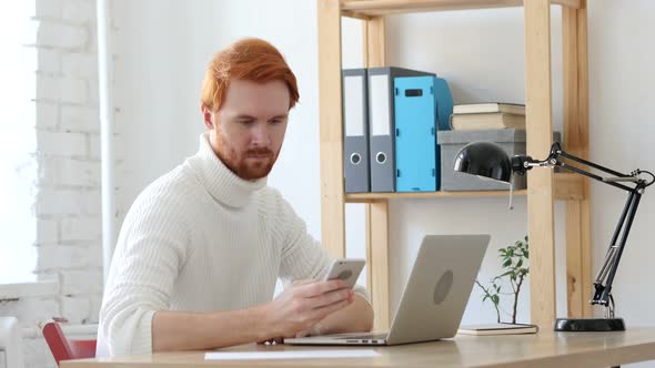 Using Smartphone, Browsing Man with Red Hairs