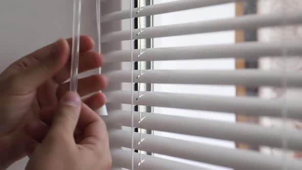 Man spying on people, using binoculars for observation