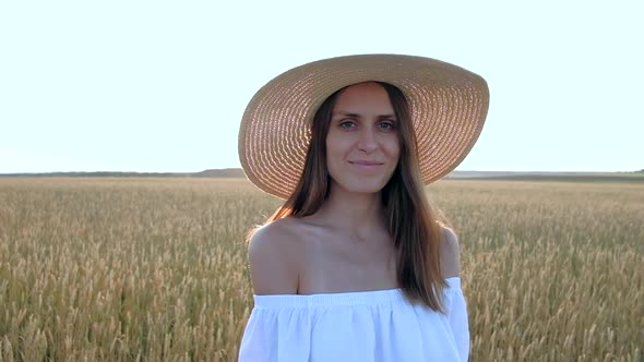 Amazing Portrait of Beautiful Woman Standing in Field of Ripe Golden Wheat