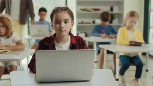 Portrait of the Girl Sitting on the Desk with Laptop in a Class During Computer Science Lesson