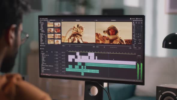 Unrecognizable Man Editing Cosmonaut Video on Computer