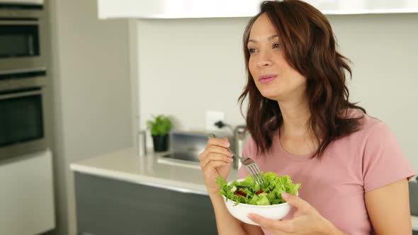 Pretty Woman Eating a Bowl of Healthy Salad