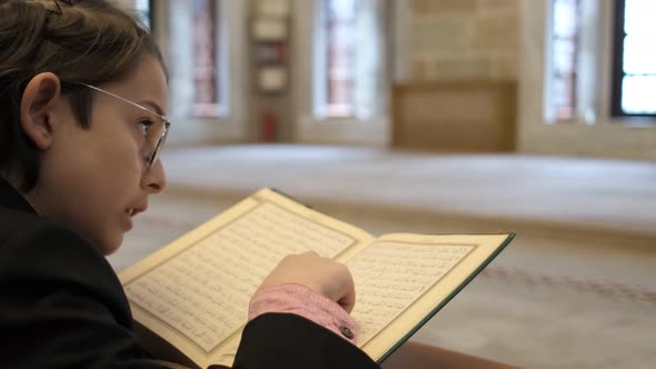 Boy Praying From Quran