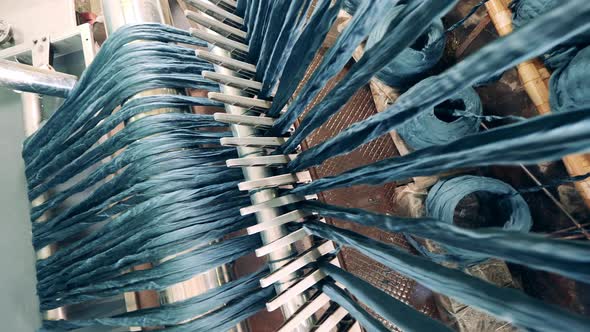 Strings of Fiber are Getting Run Through Unwinding Machine