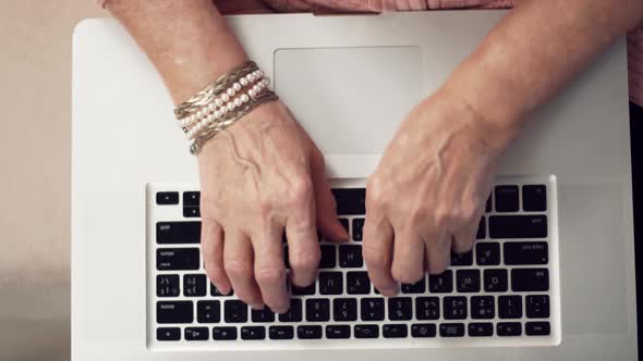 Senior Woman Hands Typing On Laptop Keyboard. Elderly Hands Typing On Notebook Keyboard.