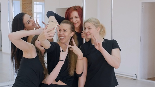 Group of beautiful young women taking a selfie with smartphone