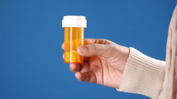 Close Up of Women Hand Holding Medical Pill Container